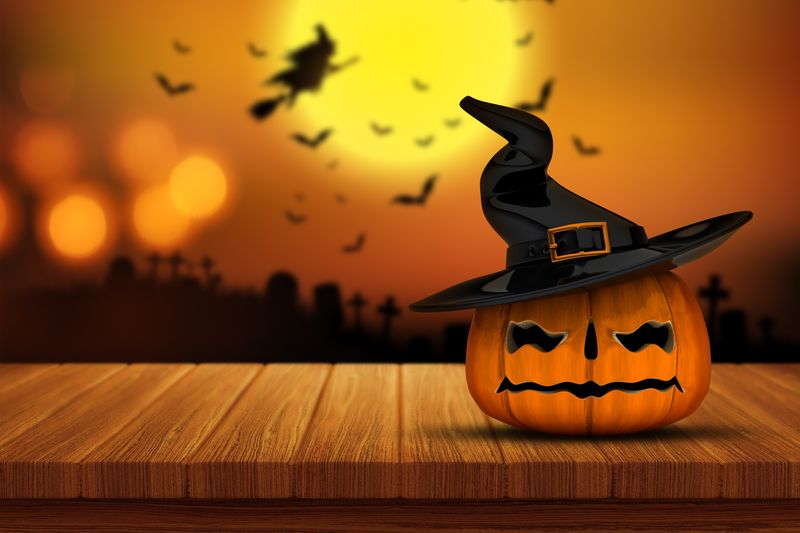 3D render of a Halloween pumpkin on a wooden table with a defocussed spooky graveyard image in the background